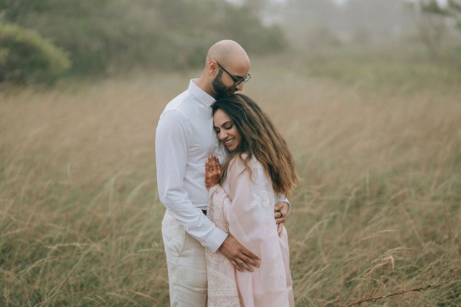 A couple embracing in a field of tall grass