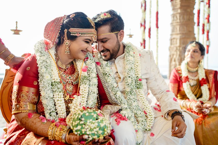Bride and groom in flower garlands