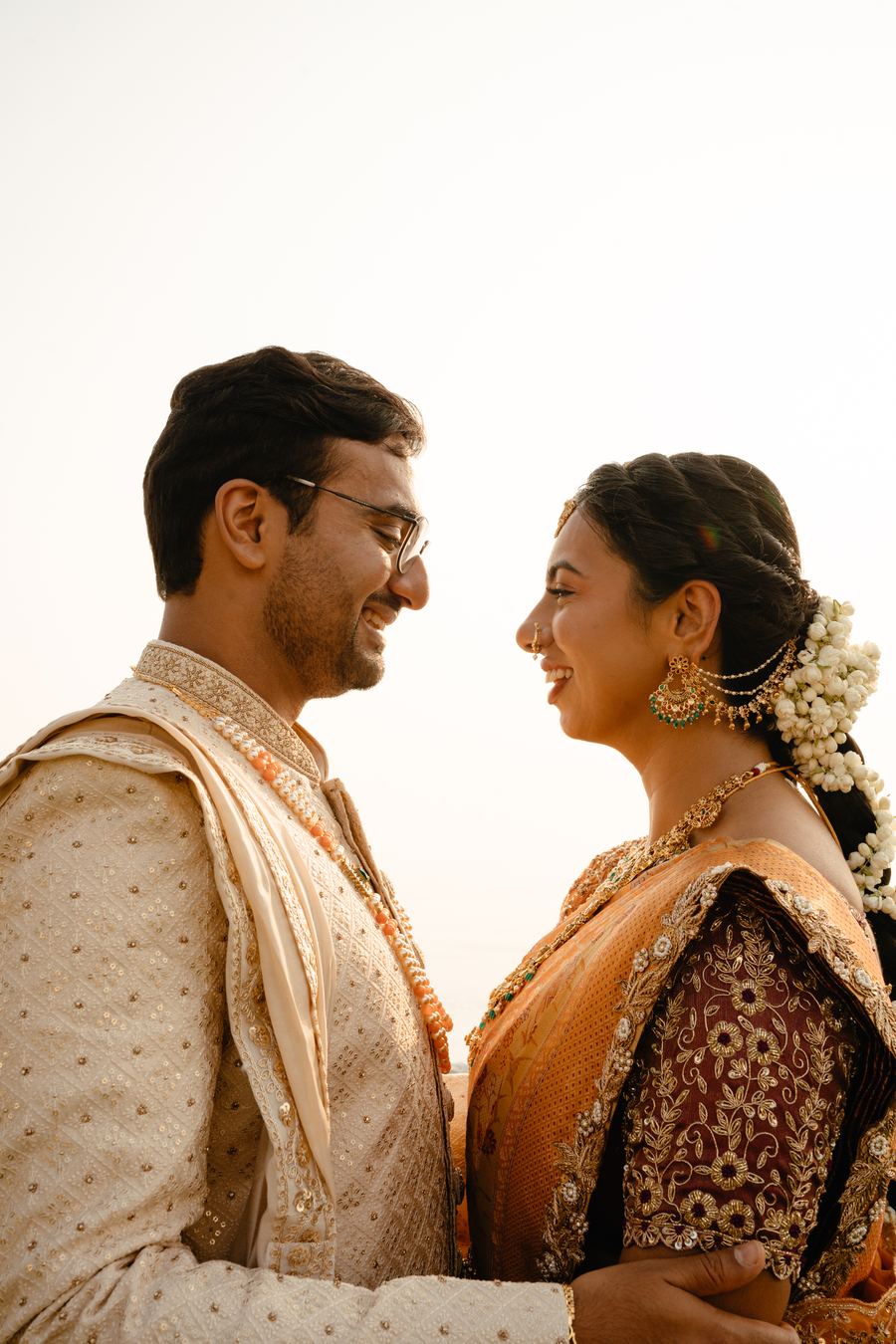 A couple facing each other, both in gold