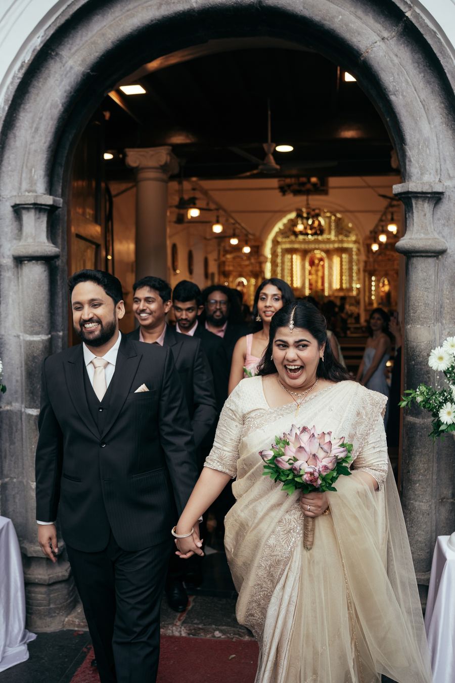 The couple leaving the church among their guests