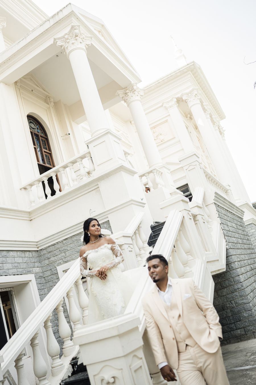 A couple on a white staircase