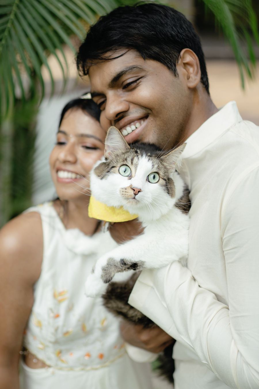A couple holding their cat