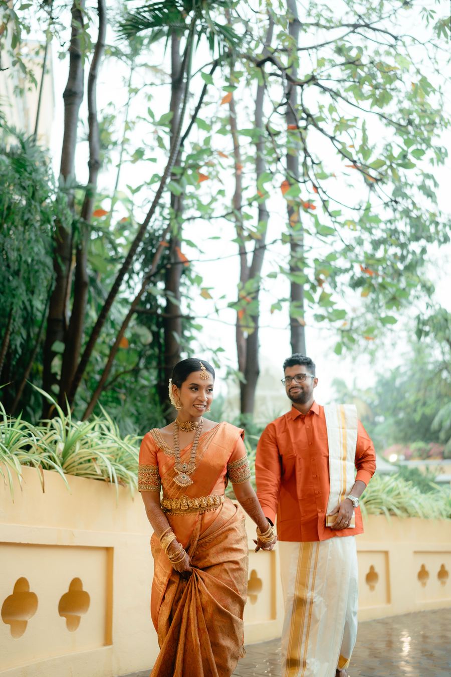 A couple in orange, walking together